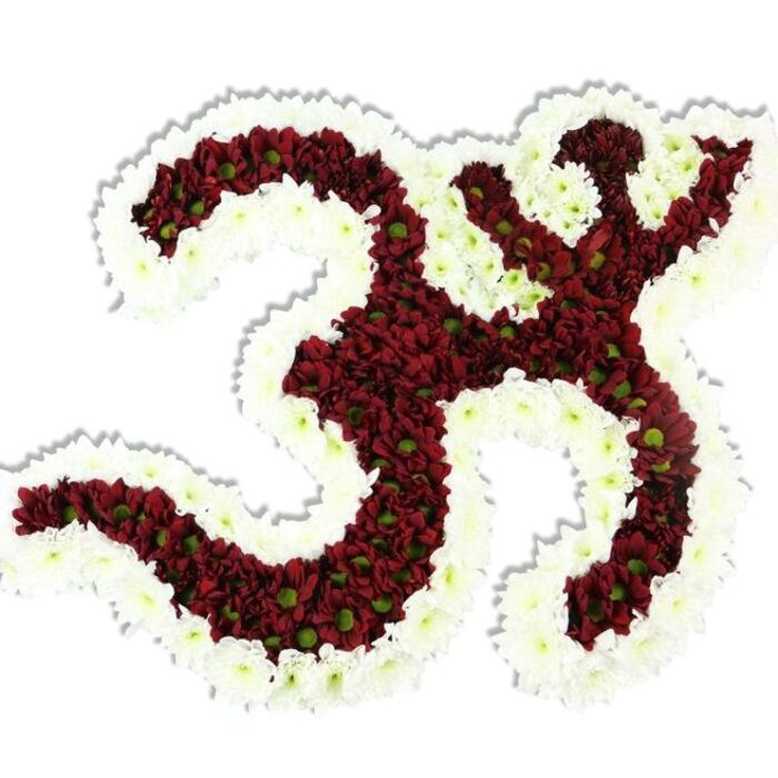 A finely crafted floral Om symbol rests against a crisp white field, its iconic curves built from thousands of small, densely packed dark red to maroon chrysanthemum-like blossoms. Each of these tiny pompon flowers bears a distinct lime-green centre, an organic punctuation that lifts the deep red mass and gives the whole design a textured, lively realism. Framing and defining every interior loop is a full, undulating border of pure white spray chrysanthemums whose petals form a clean, radiant edge against the maroon interior, making the sacred character read with immediate clarity. The assembly is sculptural in profile - rounded, lush, and carefully layered so that light falls across the petals and a soft shadow beneath hints at three-dimensional presence. You can almost sense the cool silkiness of the petals and the gentle, earthy hint of chrysanthemum perfume that would fill a quiet room. Created with local hands for ceremonies in Barkingside and surrounding Ilford neighbourhoods, this piece is well suited to cultural events, memorial tables, or contemplative gatherings near Snakes Lane and the High Street. Flower Delivery Barkingside's artisans often craft similar tributes for community centres and private observances, paying attention to the reverent mood such symbols require. The image speaks of respect, skilled floral technique, and the comforting visual language of colour and form when floral art meets spiritual purpose.