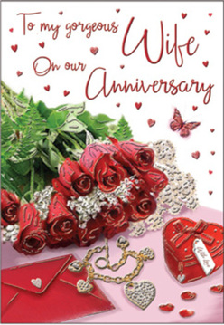 This image portrays an anniversary card scene that feels both romantic and reassuring, as if set on a sideboard in a Barkingside home after a surprise flower delivery. A compact bouquet of crimson red roses occupies the central space, their petals swirling in tight, velvety whorls that look almost tangible. Each rose catches the soft light, creating reflections and shadows that emphasise their fullness and depth. Surrounding the blooms is fresh greenery that spills outward in gentle curves, echoing the relaxed elegance of a hand-tied arrangement prepared by a local florist. To one side lies a pale envelope, slightly open, hinting at loving words penned for a partner after years together in Barkingside's familiar streets and cafés. A small, heart-shaped jewellery box in a rich, matching red is positioned nearby, its smooth surface catching subtle highlights, while a delicate necklace or pendant glimmers close to it, shaped in a way that suggests intertwined hearts or a meaningful symbol. Scattered on the background are tiny heart decorations and sparkling accents that add brightness and playful romance, and a single butterfly motif offers a light, graceful presence, suggesting transformation and new chapters in a long relationship. The composition is bathed in soft, even lighting that flatters every surface, from satin-like petals to polished metal. The overall mood is intimate and deeply affectionate, perfectly capturing the feeling of celebrating an anniversary at home in Barkingside with flowers, keepsakes, and quiet gratitude.